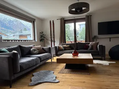 a living room with couches and a coffee table at Sauna Bain Nordique Cinéma Vue Montange in Chamonix-Mont-Blanc