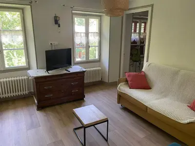 a living room with a couch and a flat screen tv at Villa la tourelle in Saint-Gervais-les-Bains
