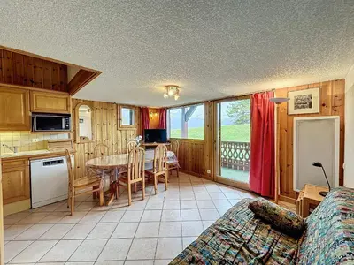 a kitchen and dining room with a table and chairs at Charmant 4 pièces avec terrasse face Mont Blanc, proche téléski, village et garage sécurisé - FR-1-560-133 in Combloux