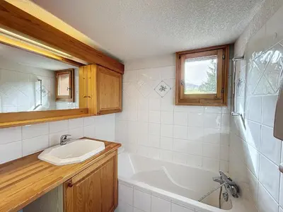 a bathroom with a sink and a bath tub at Charmant 4 pièces avec terrasse face Mont Blanc, proche téléski, village et garage sécurisé - FR-1-560-133 in Combloux