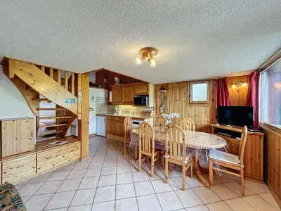 a kitchen and dining room with a table and chairs at Charmant 4 pièces avec terrasse face Mont Blanc, proche téléski, village et garage sécurisé - FR-1-560-133 in Combloux