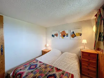 a bedroom with a bed and a dresser and two lamps at Charmant 4 pièces avec terrasse face Mont Blanc, proche téléski, village et garage sécurisé - FR-1-560-133 in Combloux