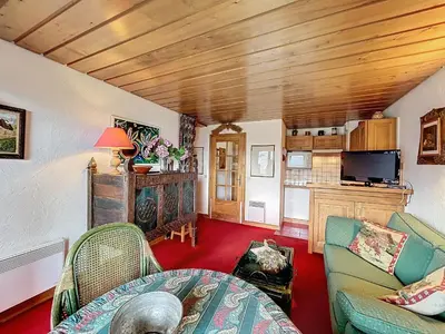 a living room with a couch and a table at Appartement 2 pièces avec parking, au pied des pistes - FR-1-560-134 in Combloux