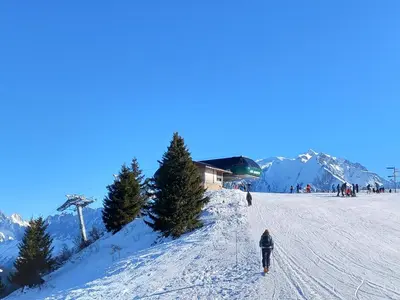 a person is skiing down a snow covered slope at Joli studio à St Gervais les bains in Saint-Gervais-les-Bains