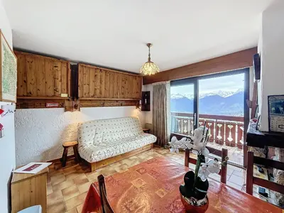 a living room with a couch and a large window at Studio cosy au pied des pistes avec parking à Combloux - FR-1-560-137 in Combloux