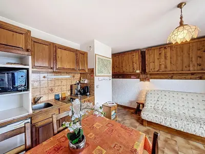 a kitchen and living room with a table and a couch at Studio cosy au pied des pistes avec parking à Combloux - FR-1-560-137 in Combloux