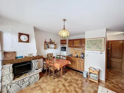 a kitchen with a table and a refrigerator at Studio cosy au pied des pistes avec parking à Combloux - FR-1-560-137 in Combloux