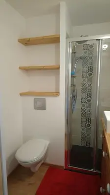 a bathroom with a toilet and a glass shower at Studio Bettex 4p- vue Mont-Blanc in Saint-Gervais-les-Bains