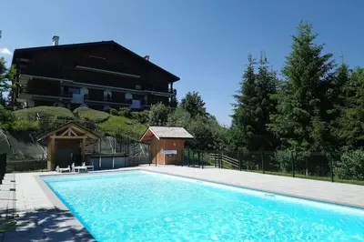 a large swimming pool in front of a building at Studio Bettex 4p- vue Mont-Blanc in Saint-Gervais-les-Bains