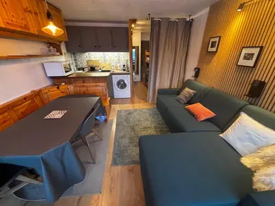 a living room with a couch and a table at Studio Bettex 4p- vue Mont-Blanc in Saint-Gervais-les-Bains
