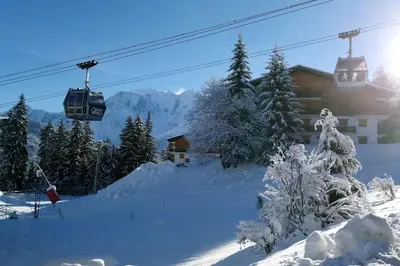a ski resort with a ski lift and snow covered trees at Studio Bettex 4p- vue Mont-Blanc in Saint-Gervais-les-Bains