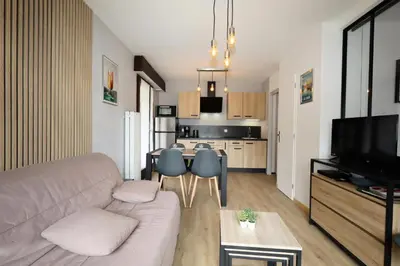 a living room with a couch and a dining room at Résidence Les Esserts - Les Esserts MAE-8381 in Les Houches