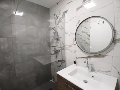 a bathroom with a sink and a shower and a mirror at Résidence Les Esserts - Les Esserts MAE-8381 in Les Houches