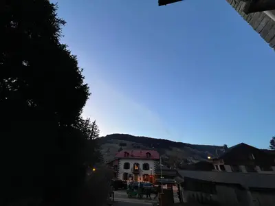 a white house with a mountain in the background at I love Megève in Megève