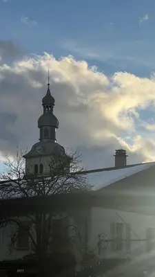 a building with a tower with a cross on it at I love Megève in Megève