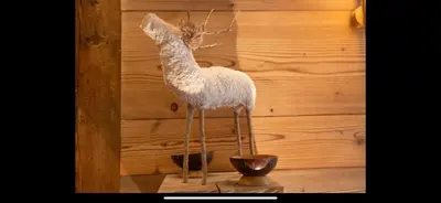 a stuffed animal is standing on a wooden wall at I love Megève in Megève