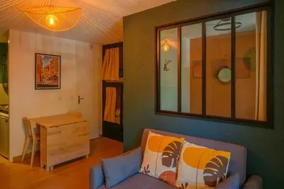 a living room with a couch and a table at Le perchoir des fées in Saint-Gervais-les-Bains