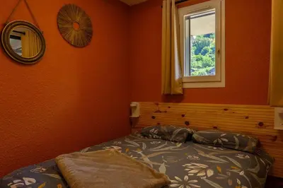 a bedroom with a bed and a window at Le perchoir des fées in Saint-Gervais-les-Bains