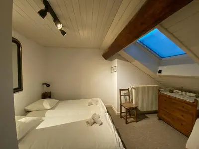 a bedroom with two beds and a sink and a window at Villa Jules in Chamonix-Mont-Blanc