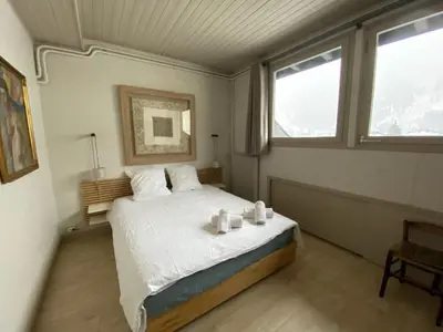 a bedroom with a bed with two candles on it at Villa Jules in Chamonix-Mont-Blanc