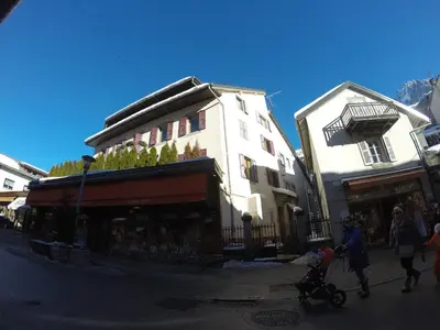 a group of people walking down a street next to a building at Villa Jules in Chamonix-Mont-Blanc