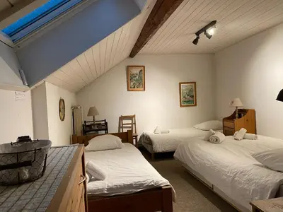 a room with three beds in a room at Villa Jules in Chamonix-Mont-Blanc