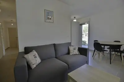 a living room with a gray couch and a table at Appartement Samoens l'Etelley in Samoëns