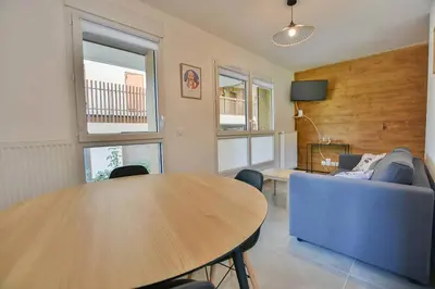 a living room with a table and a couch at Appartement Samoens l'Etelley in Samoëns