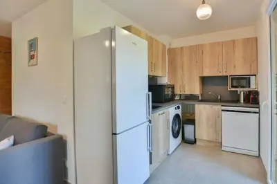 a kitchen with a refrigerator and a stove at Appartement Samoens l'Etelley in Samoëns