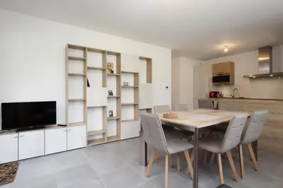 a kitchen and dining room with a wooden table and chairs at Résidence Hameau Des Reines - Hameau des Reines MAE-9981 in Servoz