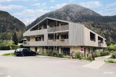 a building with a car parked in a parking lot at Résidence Hameau Des Reines - Hameau des Reines MAE-9981 in Servoz
