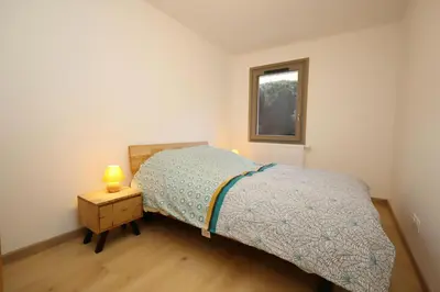 a small bedroom with a bed and a window at Résidence Hameau Des Reines - Hameau des Reines MAE-9981 in Servoz