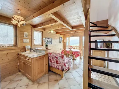 a kitchen with a staircase in a wooden house at Charmant appart 3 pièces proche des pistes avec parking et terrasse - FR-1-560-140 in Combloux