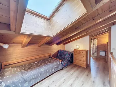 a bedroom with a bed and a wooden ceiling at Charmant appart 3 pièces proche des pistes avec parking et terrasse - FR-1-560-140 in Combloux
