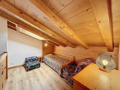 a room with a bed and two chairs in a cabin at Charmant appart 3 pièces proche des pistes avec parking et terrasse - FR-1-560-140 in Combloux