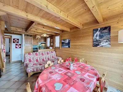 a living room with a table and a couch at Charmant appart 3 pièces proche des pistes avec parking et terrasse - FR-1-560-140 in Combloux