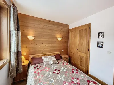 a bedroom with a bed with a quilt on it at Charmant appart 3 pièces proche des pistes avec parking et terrasse - FR-1-560-140 in Combloux