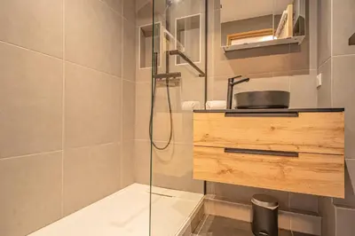 a bathroom with a glass shower with a sink at Chamois Blanc Rosières- bright 1 bed apartment with amazing views in Chamonix-Mont-Blanc