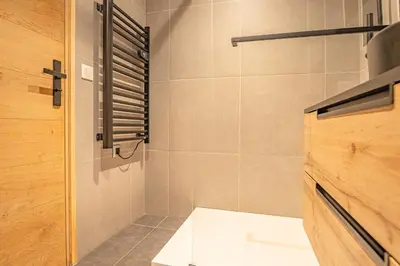 a bathroom with a shower and a toilet in it at Chamois Blanc Rosières- bright 1 bed apartment with amazing views in Chamonix-Mont-Blanc