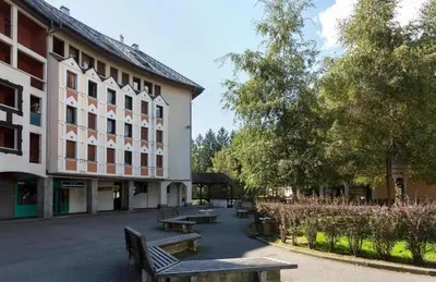 a group of benches in front of a building at Appart Les Cosmiques, Vue Mont Blanc - Aiguille du Midi in Chamonix-Mont-Blanc