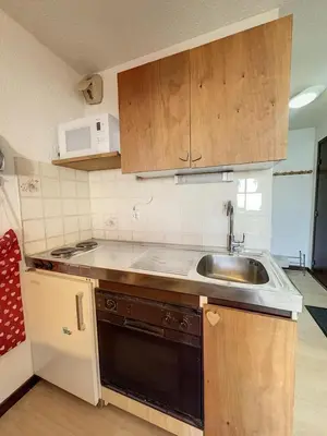 a small kitchen with a sink and a microwave at Studio Samoëns 1600 station de ski in Samoëns