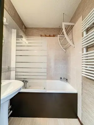 a bathroom with a bath tub and a sink at Studio Samoëns 1600 station de ski in Samoëns