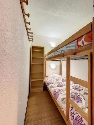 a small room with two bunk beds in it at Studio Samoëns 1600 station de ski in Samoëns