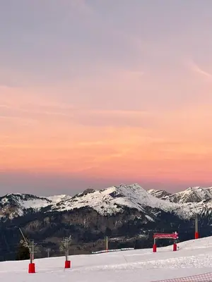 a snow covered mountain with red objects in the snow at Studio Samoëns 1600 station de ski in Samoëns