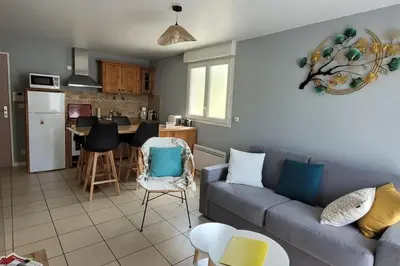 a living room with a couch and a kitchen at Appartement l'Étoile pour 1 à 4 personnes in Sallanches