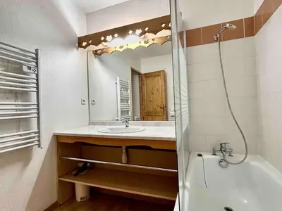 a bathroom with a sink and a mirror at Studio confortable avec parking et animaux admis - FR-1-629-139 in Samoëns