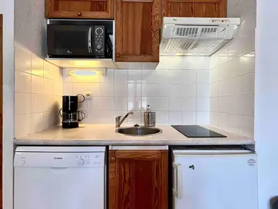 a small kitchen with a sink and a microwave at Studio confortable avec parking et animaux admis - FR-1-629-139 in Samoëns