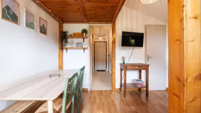 a dining room with a table and a desk at LES ARCADES - 310 - Appt accueillant 4-6 pers in Morillon