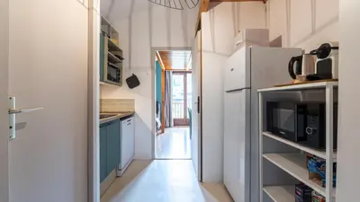 a kitchen with blue cabinets and a refrigerator at LES ARCADES - 310 - Appt accueillant 4-6 pers in Morillon