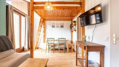 a living room with a table and a dining room at LES ARCADES - 310 - Appt accueillant 4-6 pers in Morillon